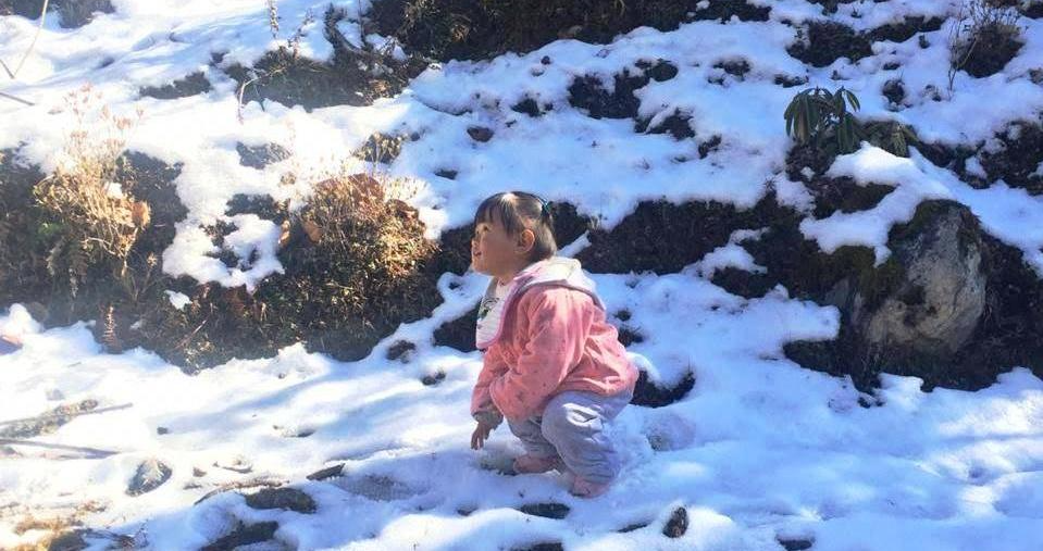 Little girl playing in the snow